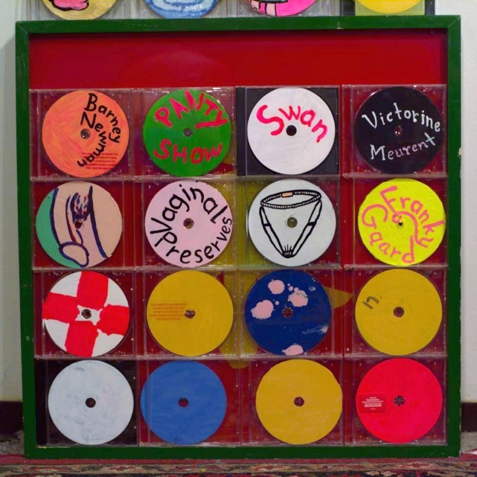 CDs on top of Ken’s glass painting  first .time I started using grids trying to organize all these tiny pain.tings . Made in studio in basement  rear of 3844 Nicollet  Avenue South  after 1999 .
